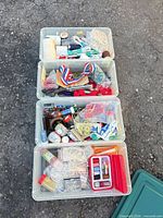 Four clear plastic tubs with assorted sewing and craft items