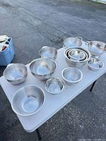 Overview of entire twelve-piece stainless steel bowl and colander set on table