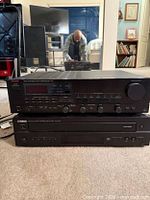 Front view of Luxman receiver stacked on Yamaha CD player