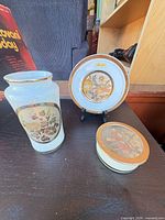 All three porcelain chokin pieces and stand together