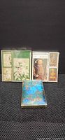 Three boxed Piatnik bridge card sets: green floral, Holbein portrait, blue abstract
