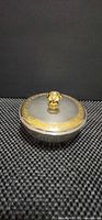 Closed dish showing silver body and gold gilt rim and knob