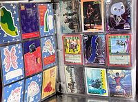 Two binder pages showing Toy Story puzzle back cards and assorted fantasy, anime and character cards