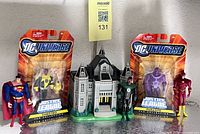 Group shot of all items: two sealed carded figures, three loose figures, building playset