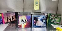 Front row CDs including Bush “Razorblade Suitcase”, Macy Gray “On How Life Is” and additional titles on shelf