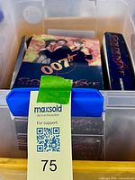 Overview of plastic tote holding three GoldenEye trading card boxes