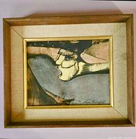 Front view of framed abstract portrait painting