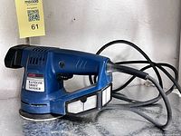 Left side view of Ryobi RS-115 sander showing dust box and power cord
