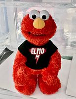 Front view of Elmo plush showing shirt and overall appearance