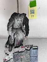 Full view of Marv statue on base with accessories laid out