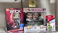 The Rock Pop Tee box, Triple H & Shawn Michaels 2-pack, sealed mystery keychain box on shelf