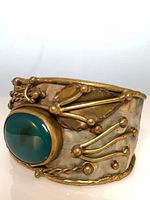 Front view of cuff showing cabochon and flourishes