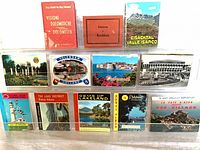 Front covers of all 12 postcard booklets displayed in two rows