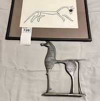 Framed print and cast metal sculpture together