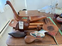 Top view of swan bowl, tray, bellows, pestles, and bird figures on table