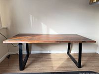 Full view of table showing rectangular shape, wood top, metal legs