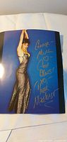 Full view of signed 8x10 photograph showing actress pose and autograph