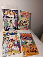 Four Archie comic books laid out showing covers