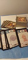 Stack of fantasy battle cards with several text-side cards spread in front