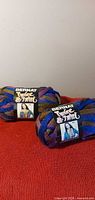 Two Bernat Twist & Twirl skeins on surface