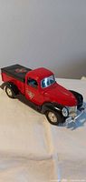 overall view of red and black die-cast pickup bank