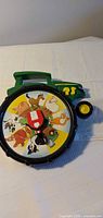 Front view of John Deere animal sound spinner showing animal wheel and tractor shape