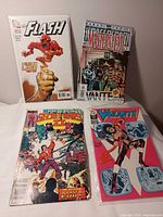 Four bagged comics displayed