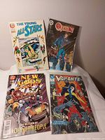 Group shot of four DC comics: The Young All-Stars, The Question, New Gods No.14, Vigilante