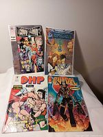 Four bagged comics laid out: Deathmate, Robotech II, DHP, Chapel