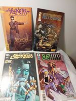 Front covers of all four bagged comic books