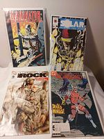 Four bagged comics front view