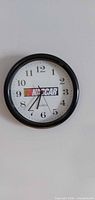 Front view of black-framed NASCAR wall clock