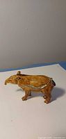 Left side view of brown enamel tapir figurine with rhinestone-lined hinge