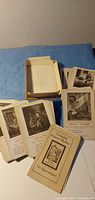 Spread of vintage quartett cards beside box bottom
