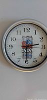 Front view of clock showing face, numerals and Coors Light graphic