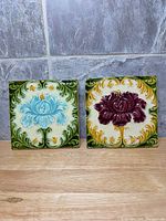 Front view of both tiles showing floral designs and colors