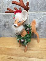 Front view showing antlers, hat, garland and beard