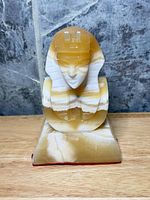 Front view of banded onyx Egyptian Sphinx bust on plinth
