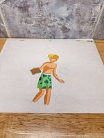 Full view of cel showing blonde boy holding book; backing paper visible