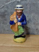 Front view of glazed porcelain standing Toby jug showing colour details and inscription on base