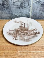 Front view of decorative plate showing entire graphic and gilt rim