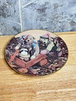 Front view showing teddy bear artwork and gold rim