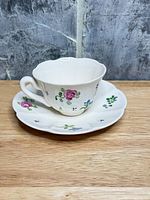 Teacup on saucer front view showing floral design