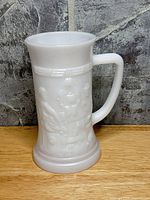 Front view showing overall shape, relief scene and handle