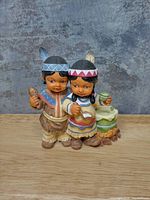 Front view of painted resin figurine pair