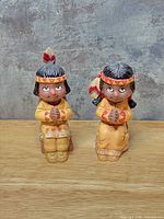 Front view of both figurines showing design and paint colors