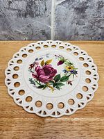 Front view showing floral design and pierced rim