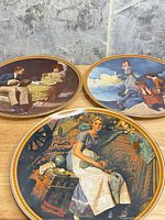 Three plates laid out showing imagery and gold rims