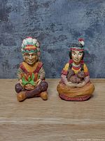 Front view of both painted resin figurines