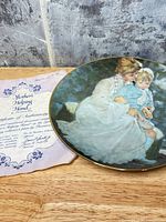 Plate and certificate displayed on wooden surface